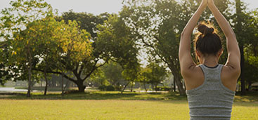 Woman at park doing yoga